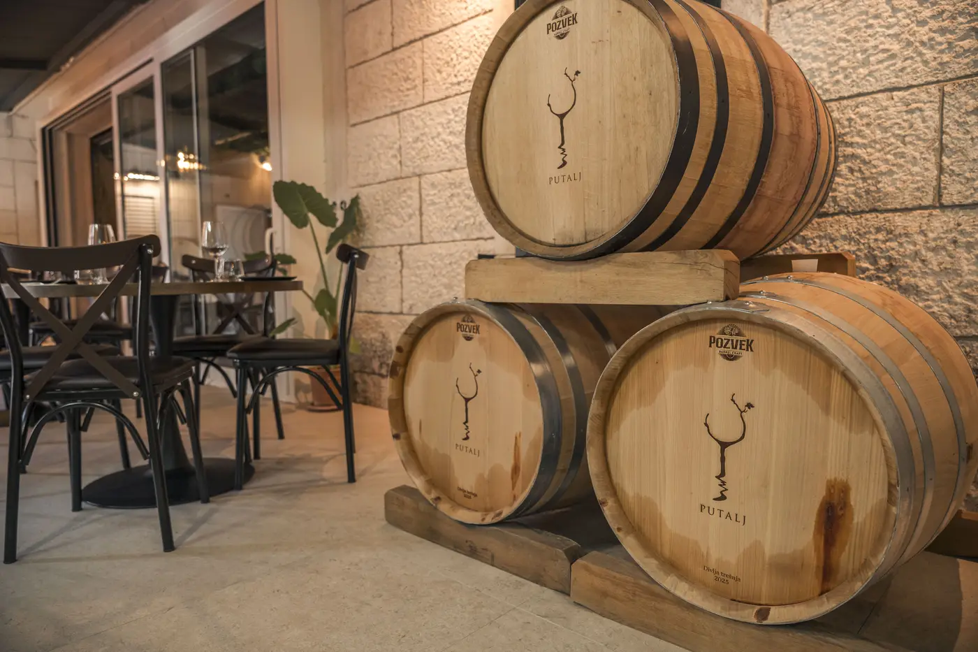 Putalj-branded oak barrels stacked beside the tasting tables